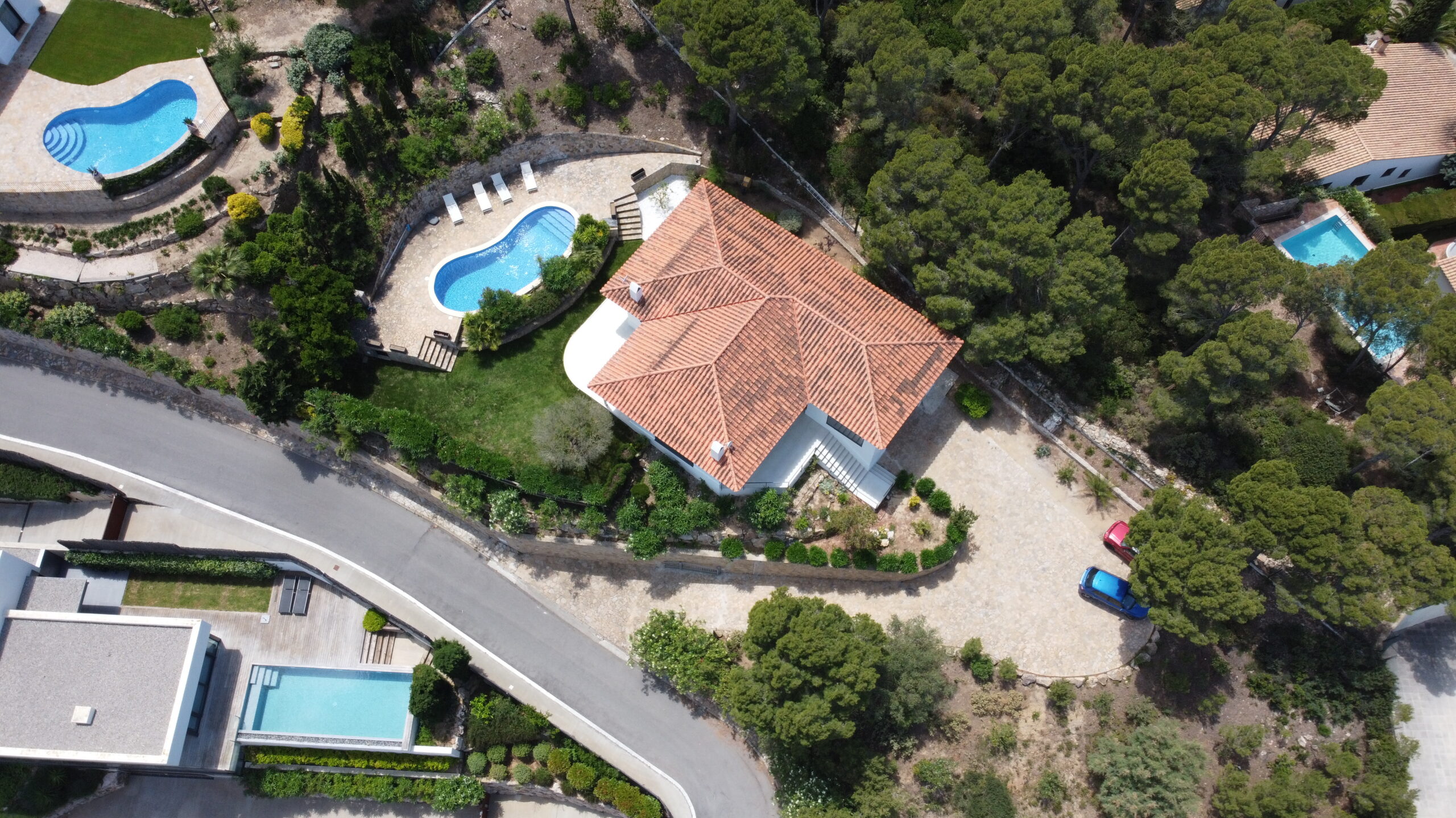 Aerial view of a private estate with pools and mature trees