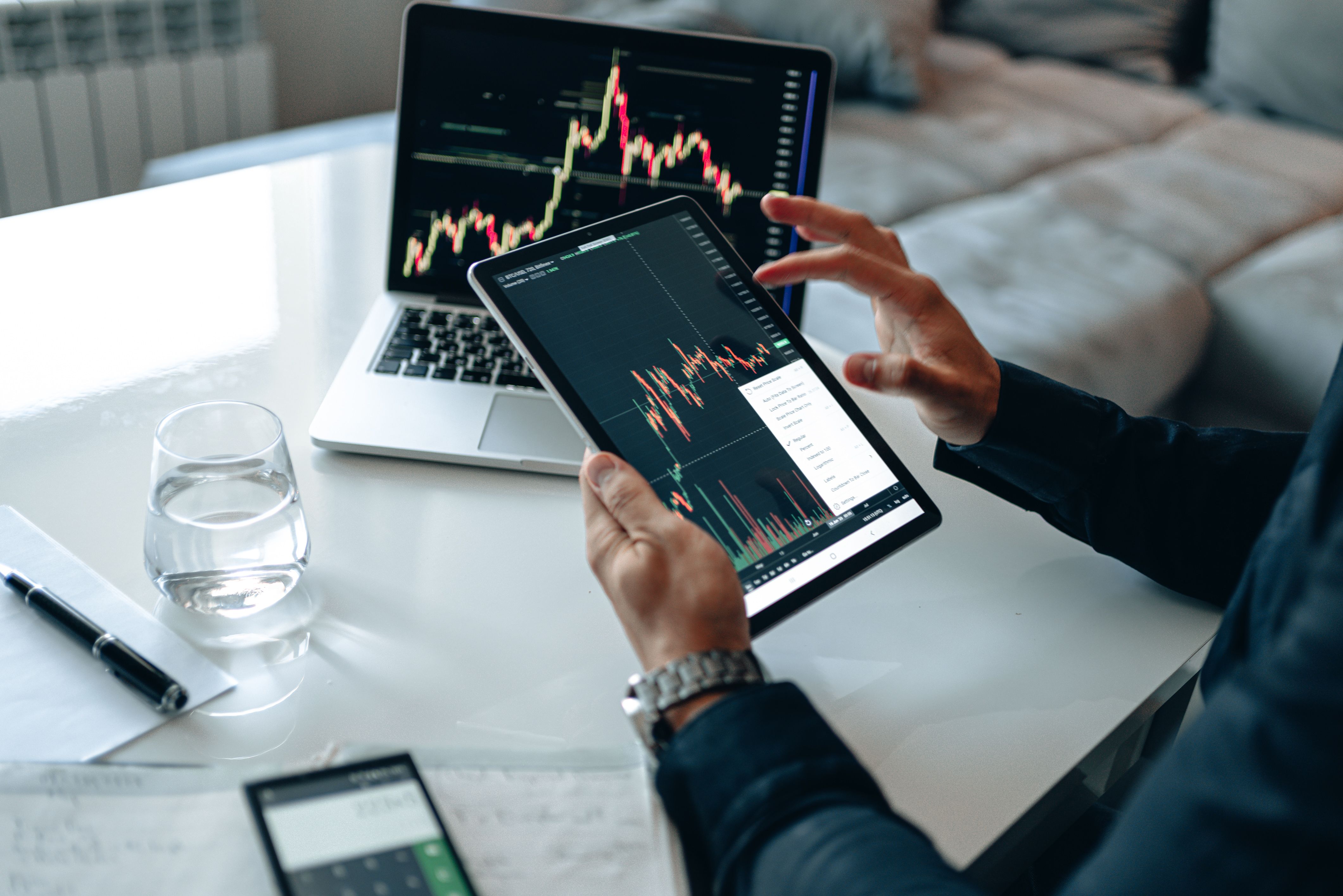 A trader reviewing technical analysis patterns on a tablet between meetings