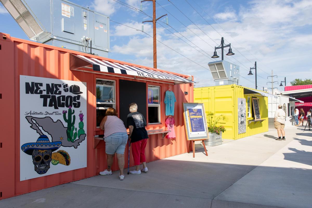 A colorful Mexican food truck parked at a food park