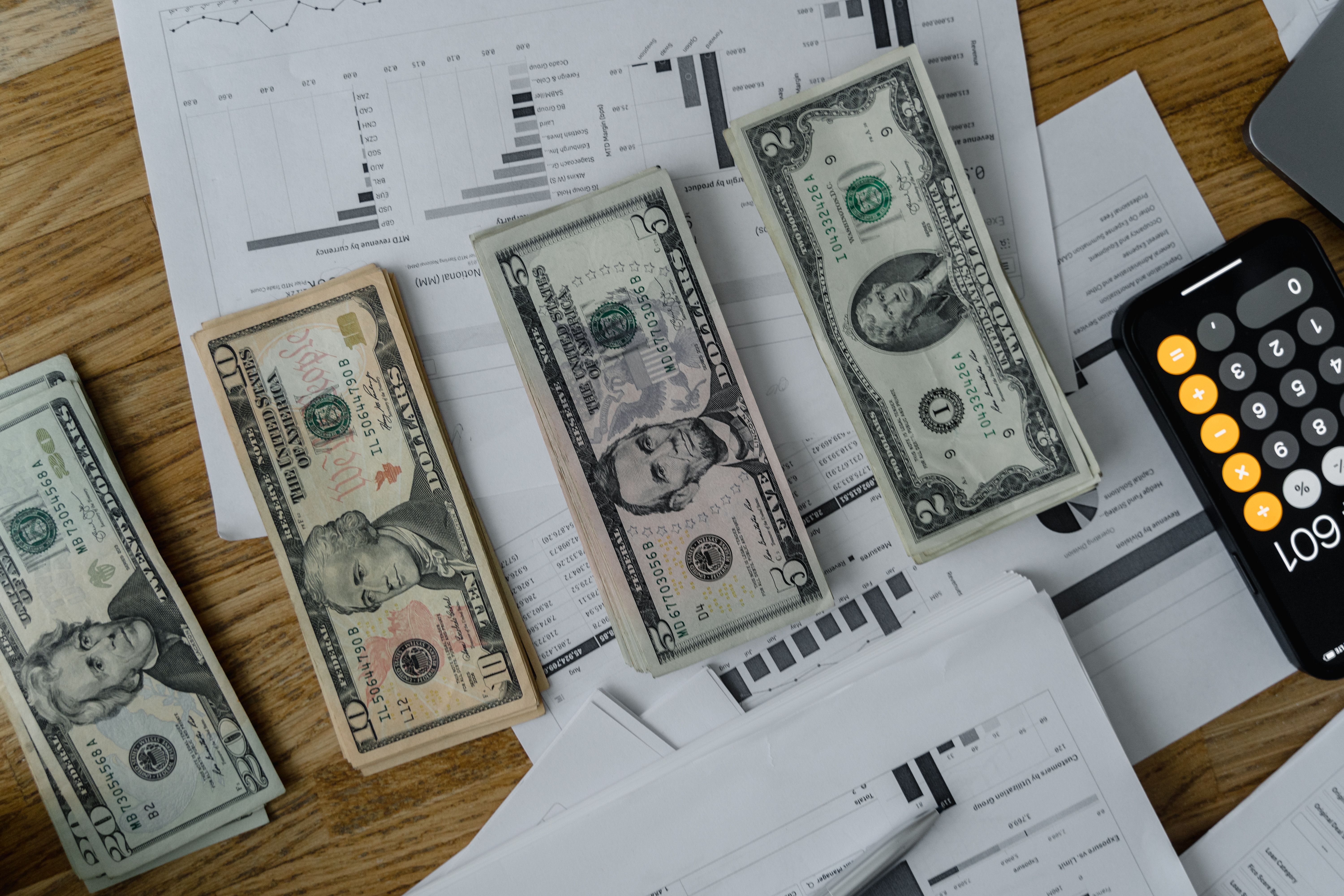 A calculator beside cash and documents, the fee math behind every robo-advisor decision