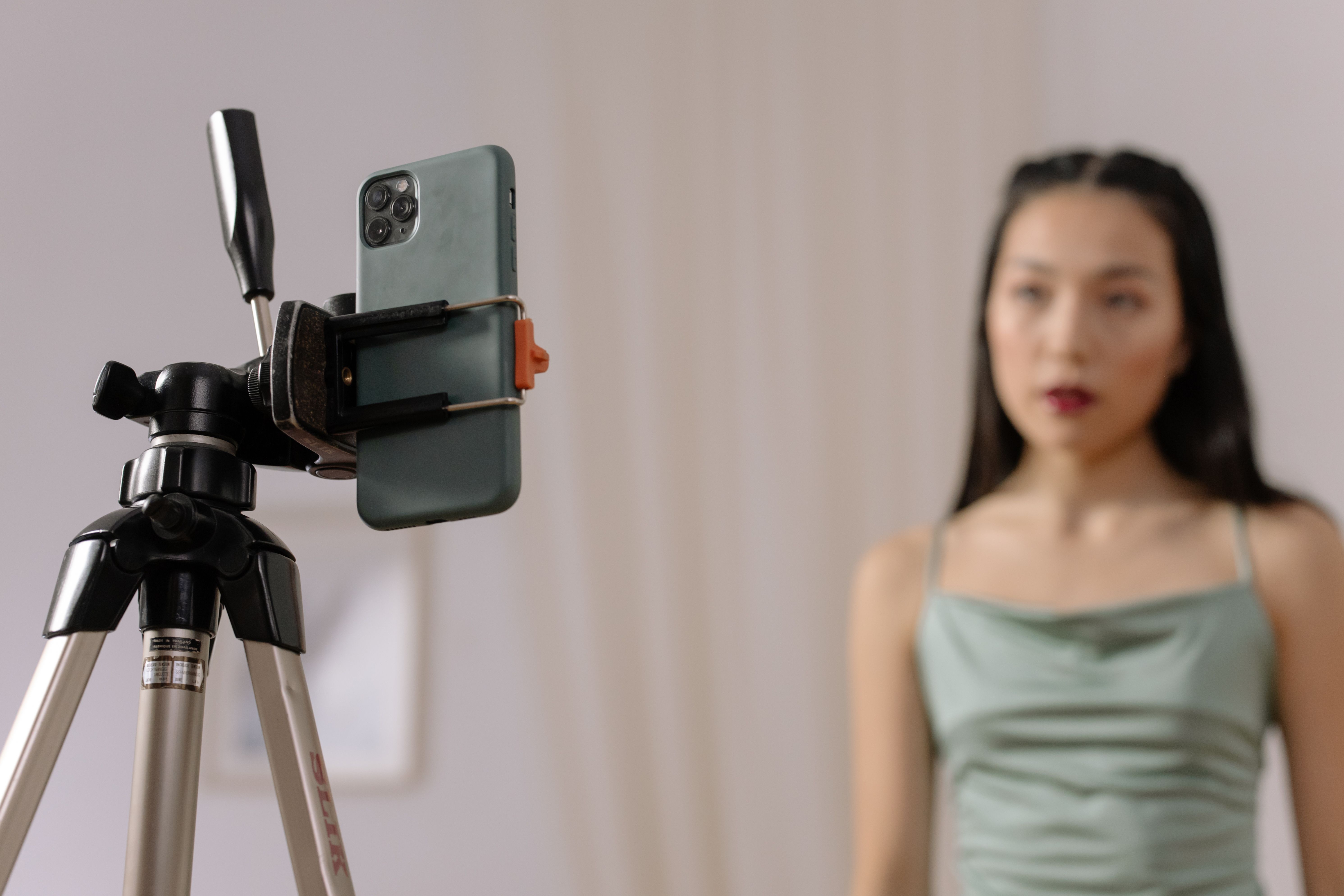 A creator filming herself with a phone on a tripod, the authentic setup user generated content ads are known for