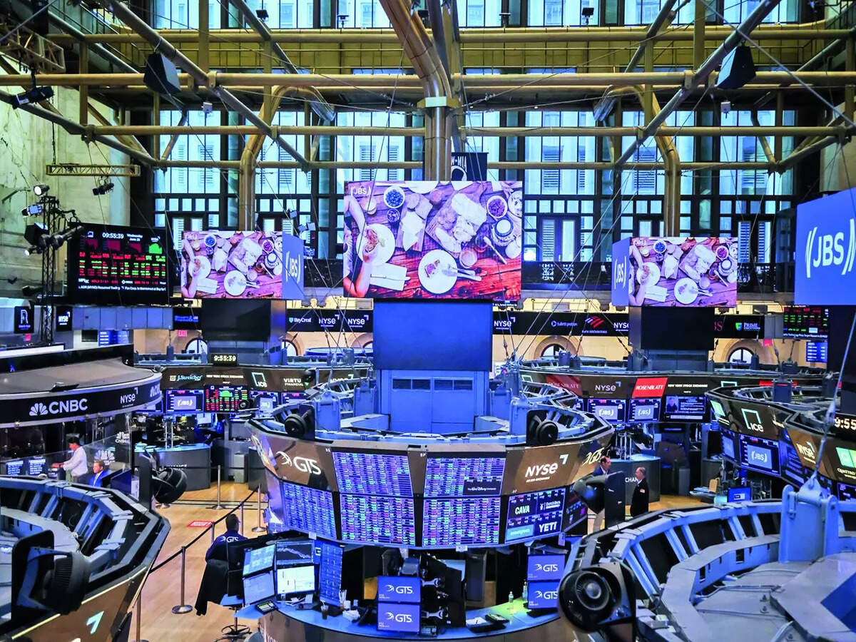 Traders working the floor as screens turn red during extreme market volatility
