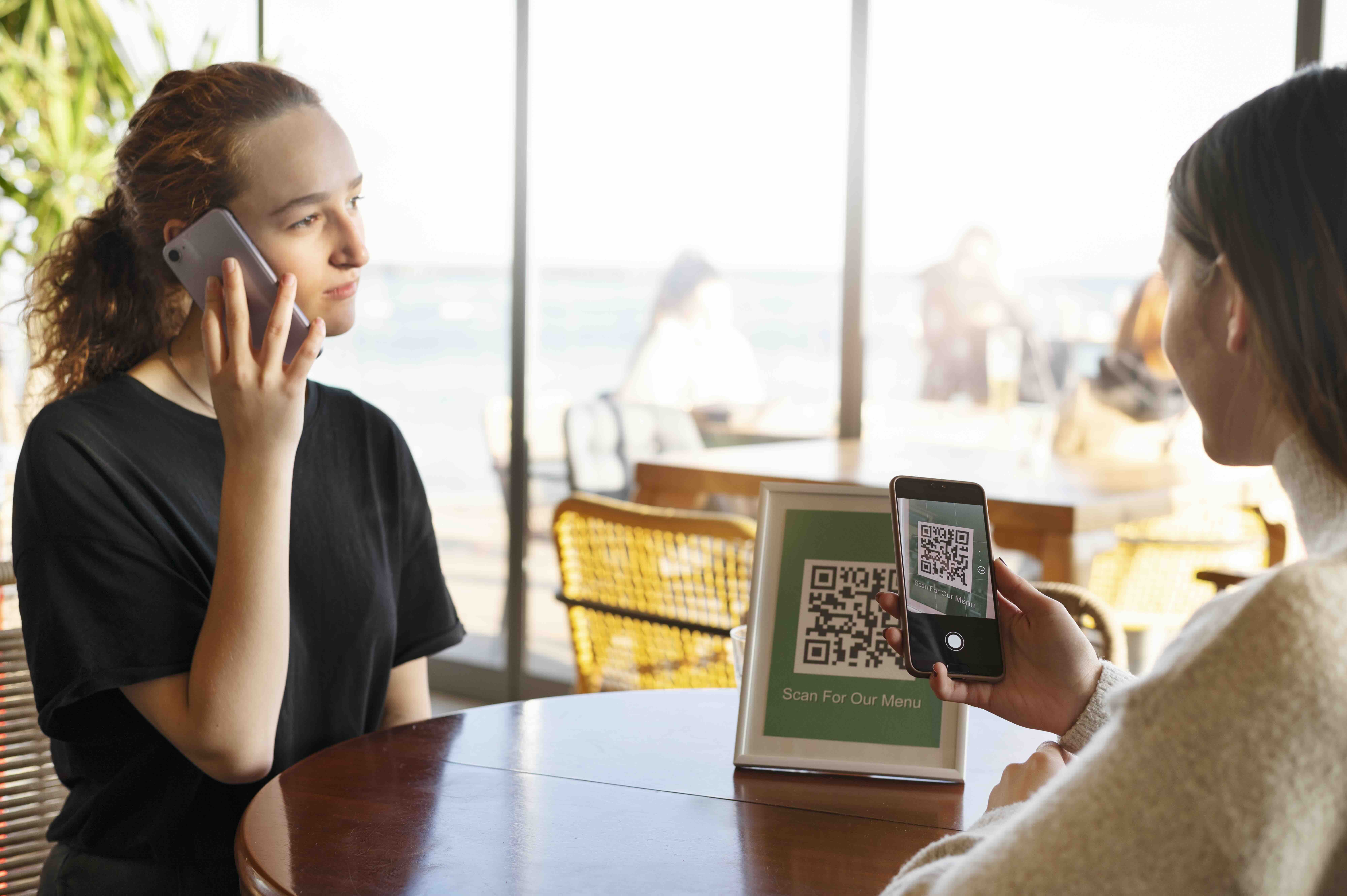 Guest scanning the QR code on a restaurant table to open the digital menu