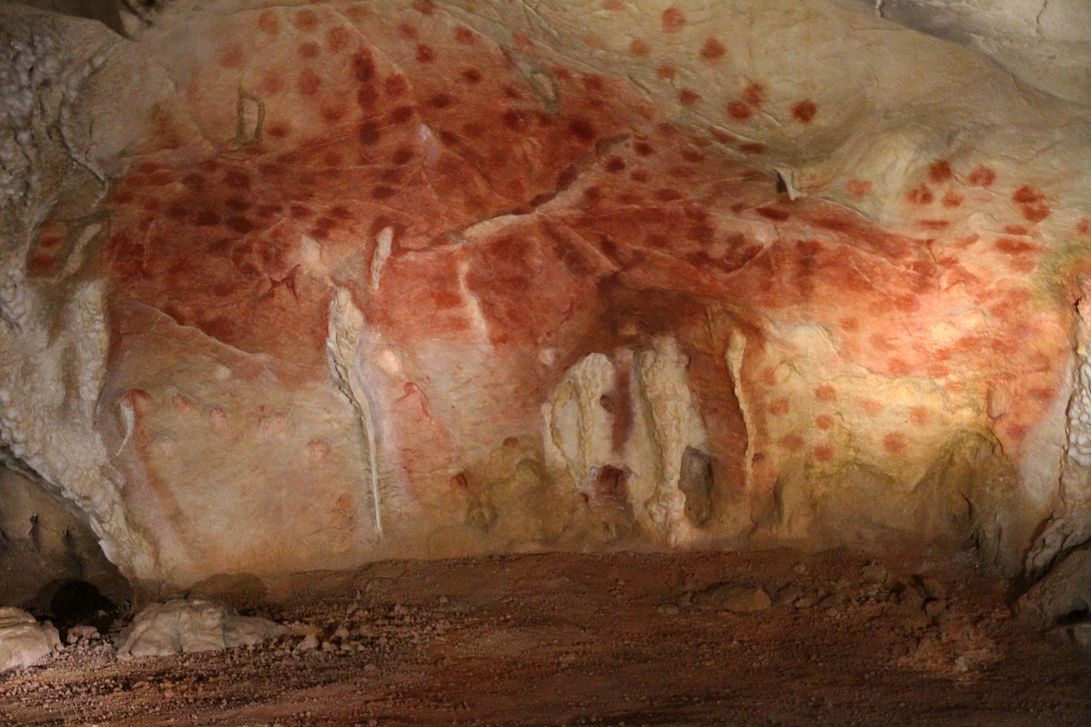 Chauvet cave interior with red ochre dots.