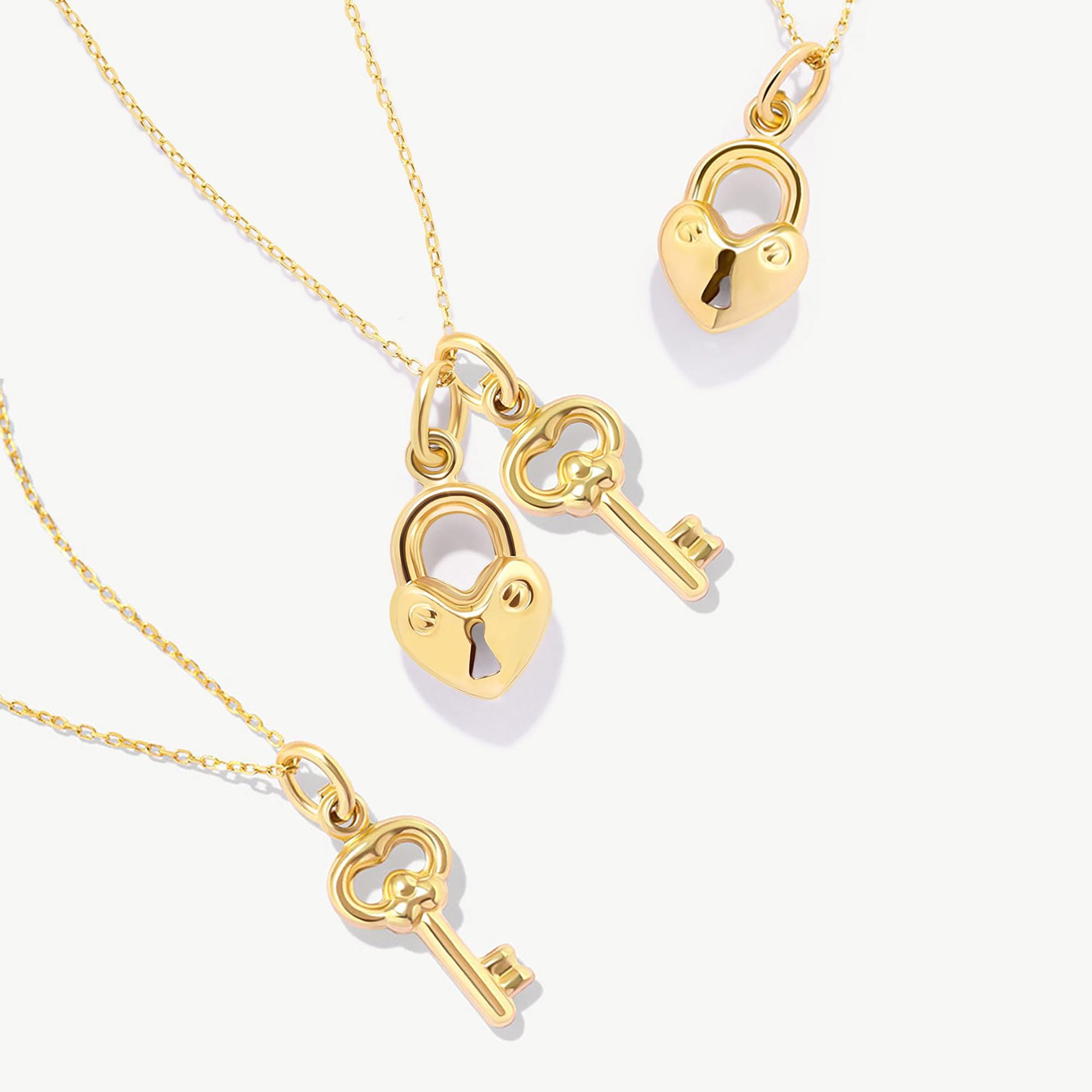Ada heart locket and key pendant in solid gold on a clean background
