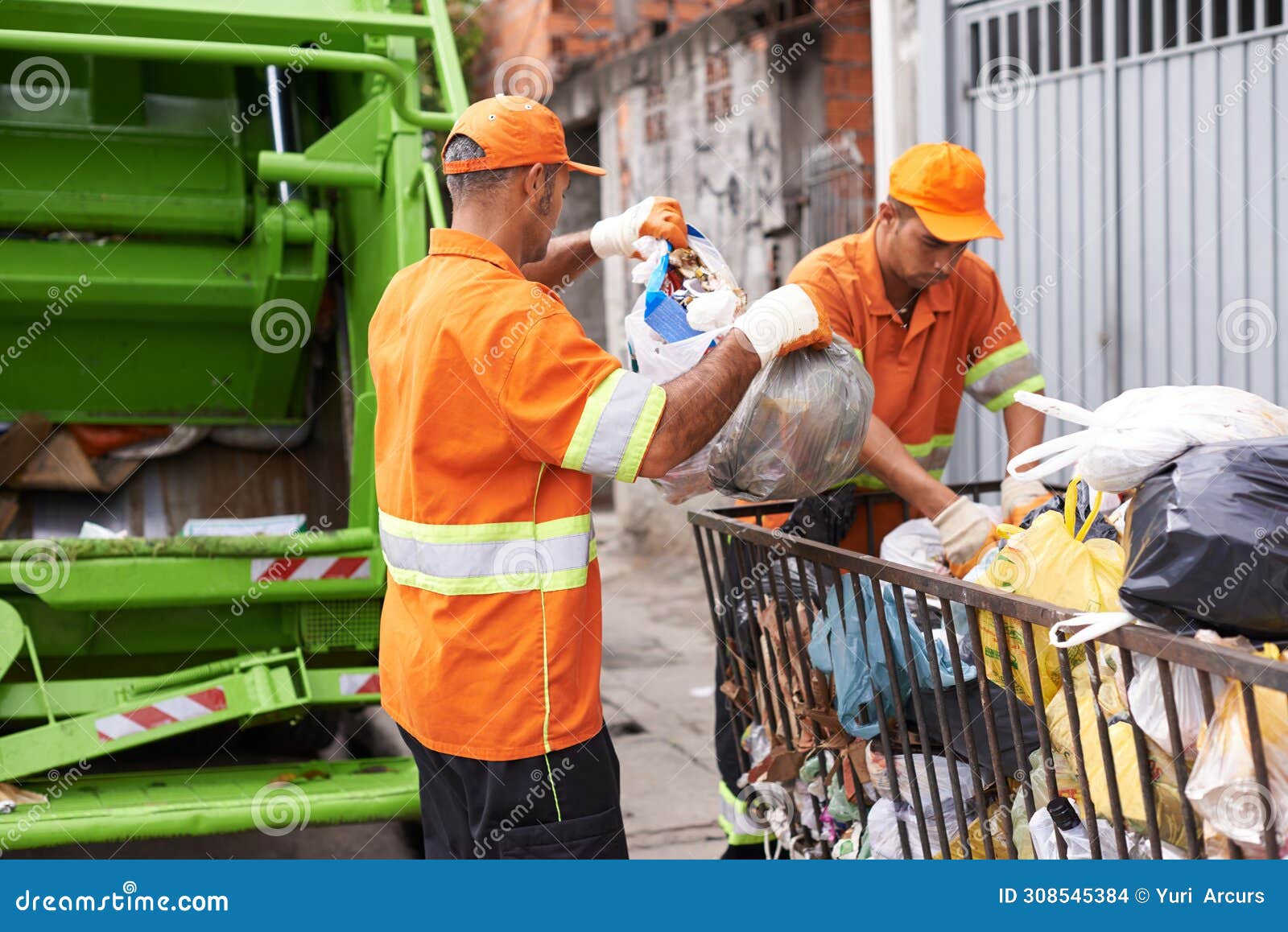 Construction worker in hard hat clearing waste on site