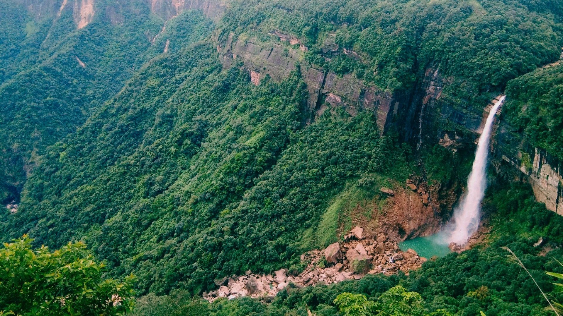 Nohkalikai waterfall cascading into a turquoise pool
