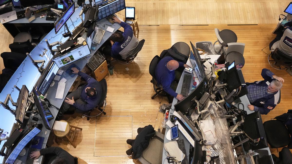 An overhead view of the stock exchange floor, the human layer above the machines