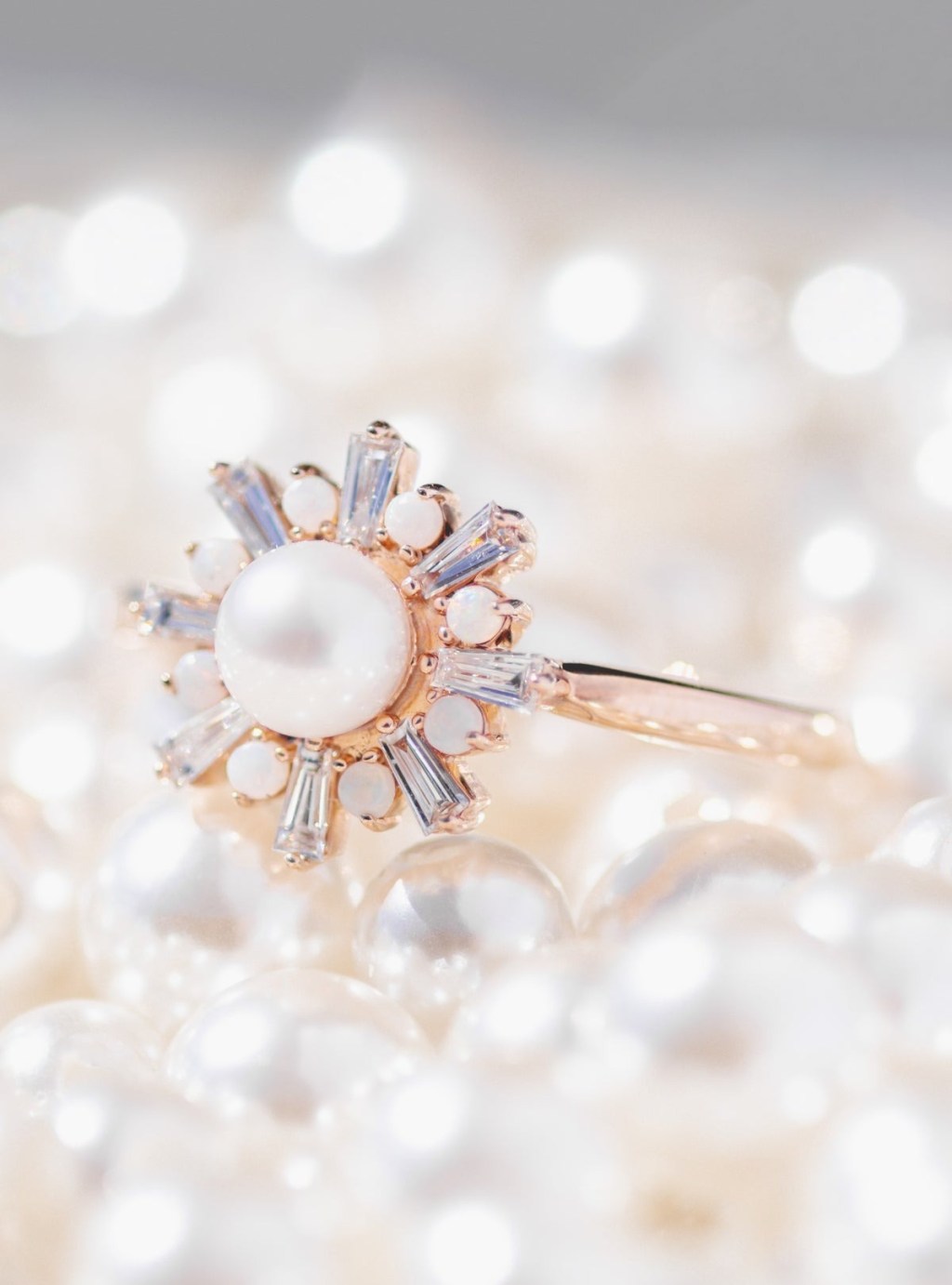 Vesper sunburst ring with Akoya pearl resting on lustrous silk