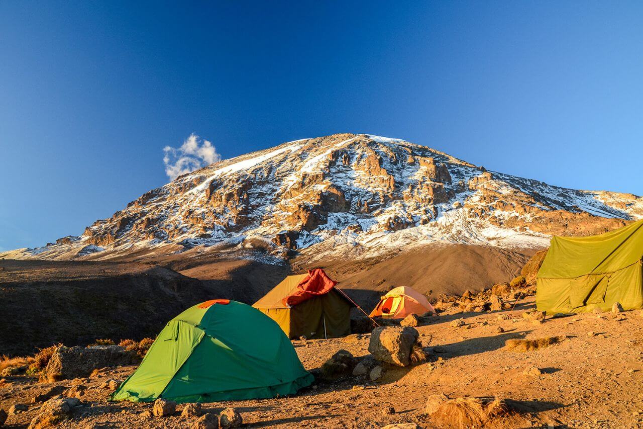 Expedition tents on a Kilimanjaro shoulder at dusk
