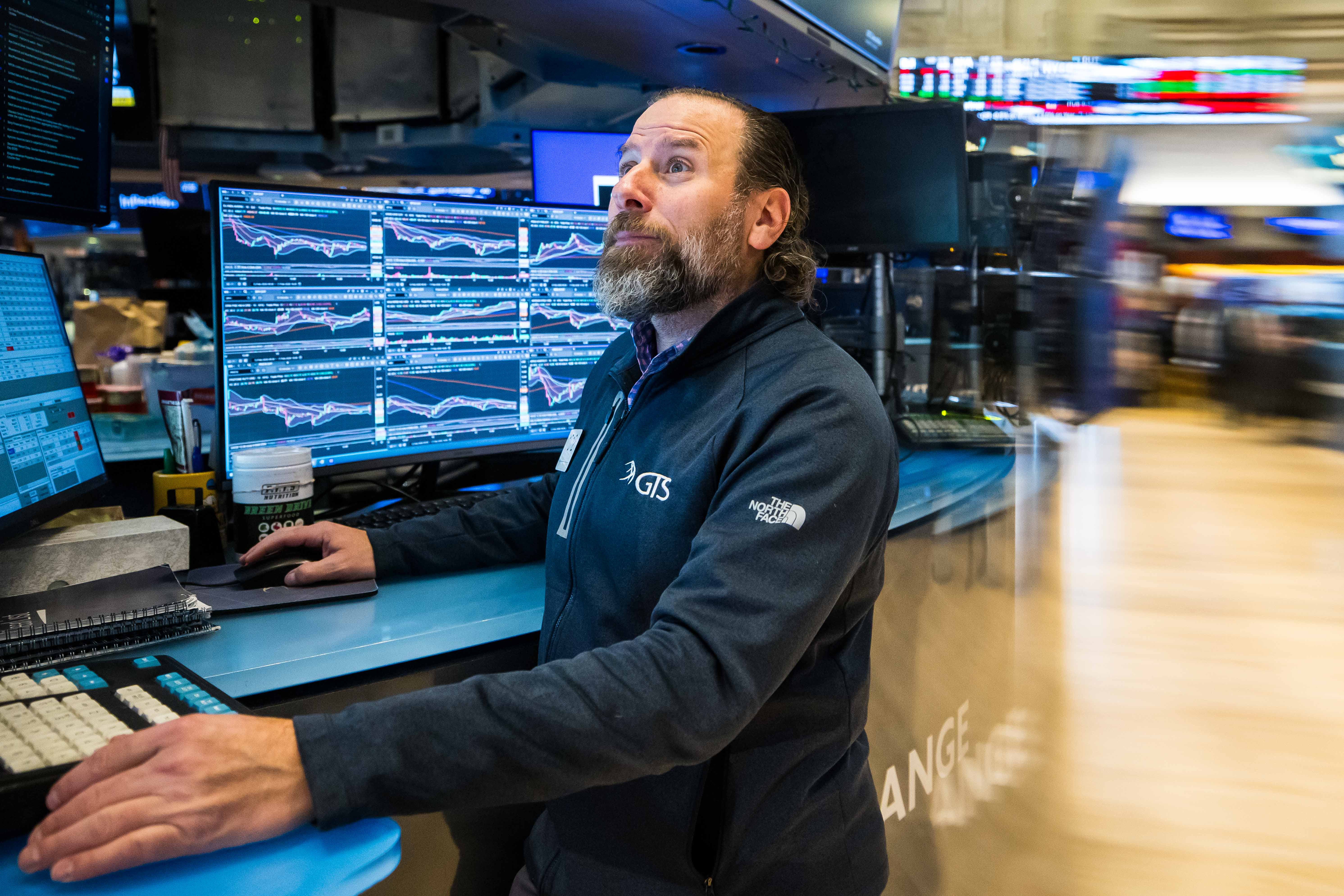 A trader watching live charts, the human front end of an AI trading bots setup