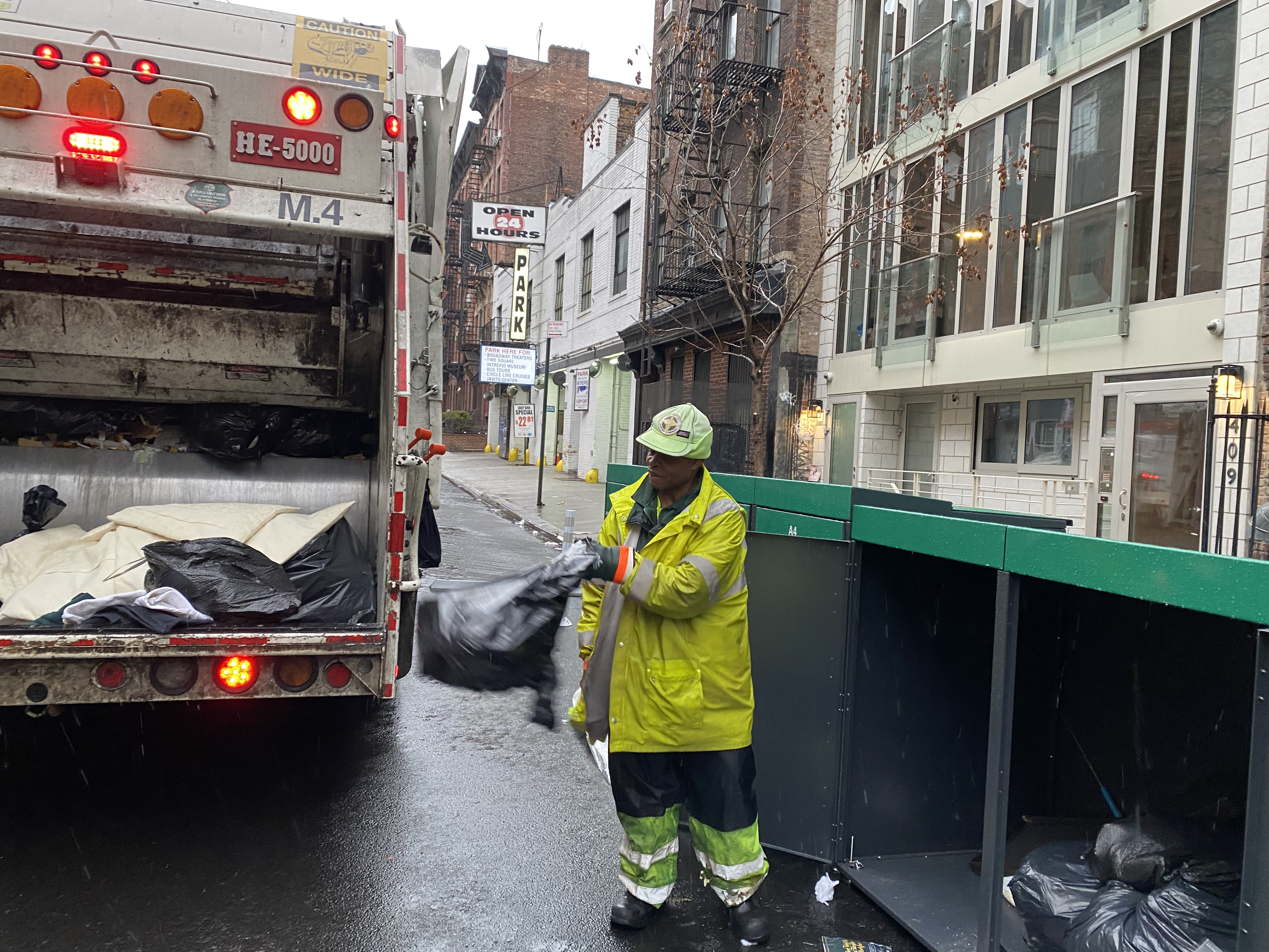 Garbage truck collecting rubbish from a city street