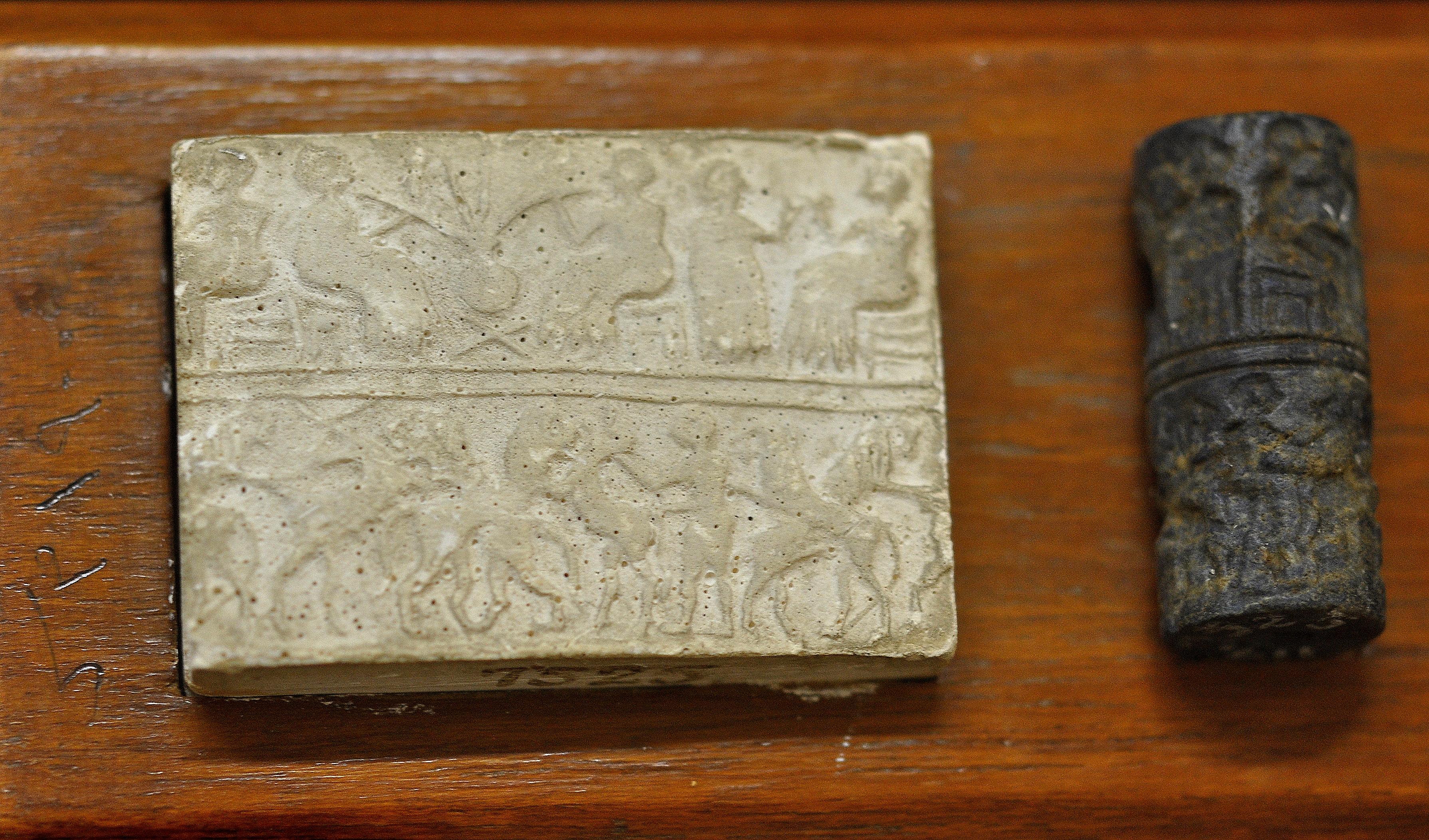 Akkadian cylinder seal beside its modern impression.