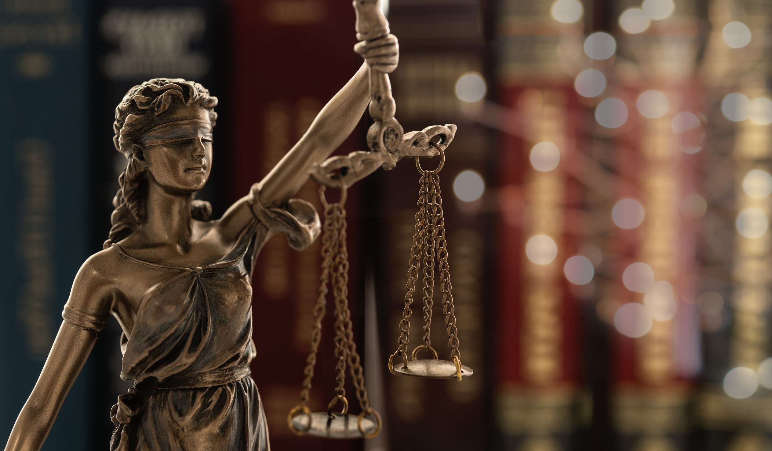 Lady justice statue with law books - top motorcycle accident lawyers in the United States