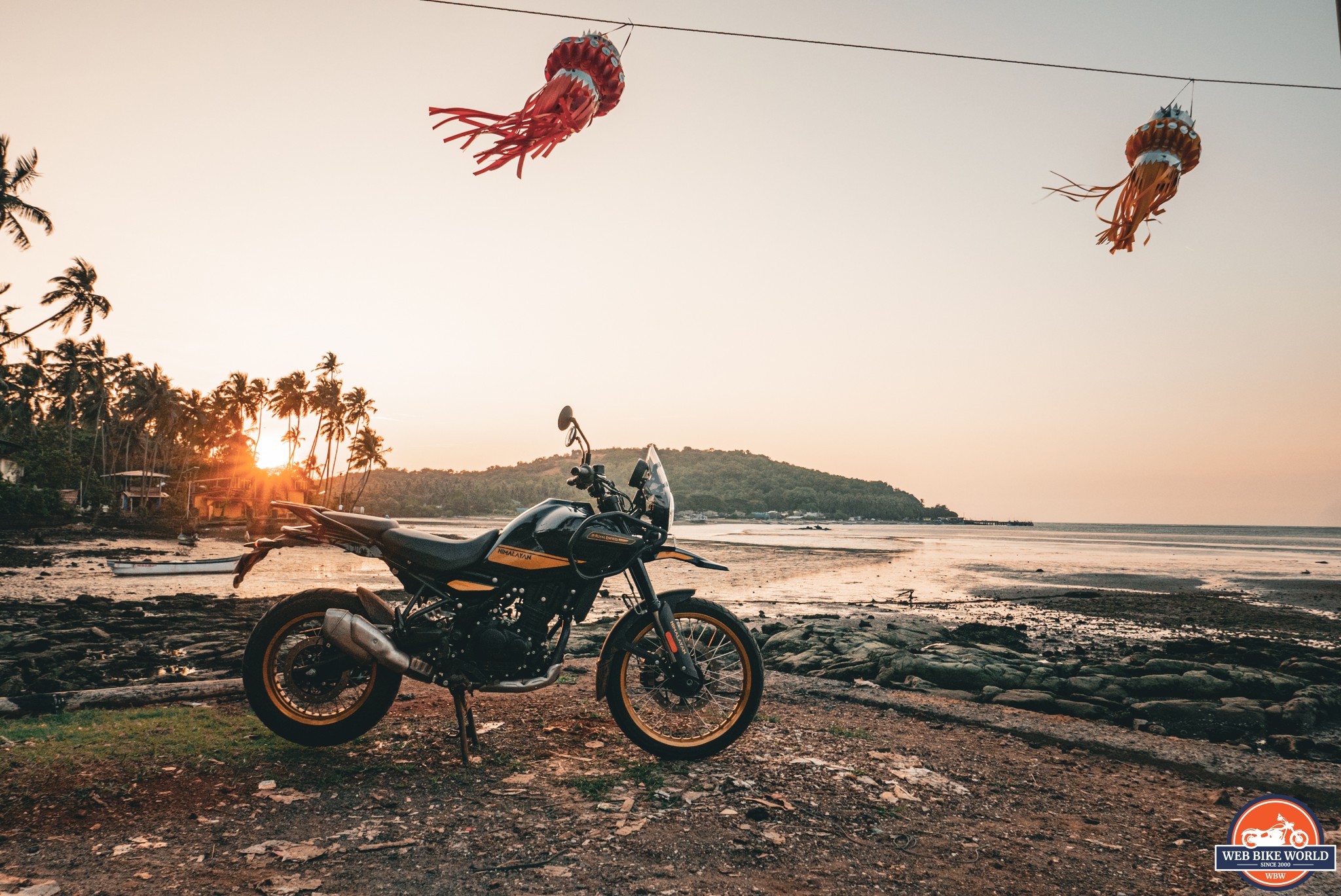 Sunset over a mountain pass with a lone motorcycle