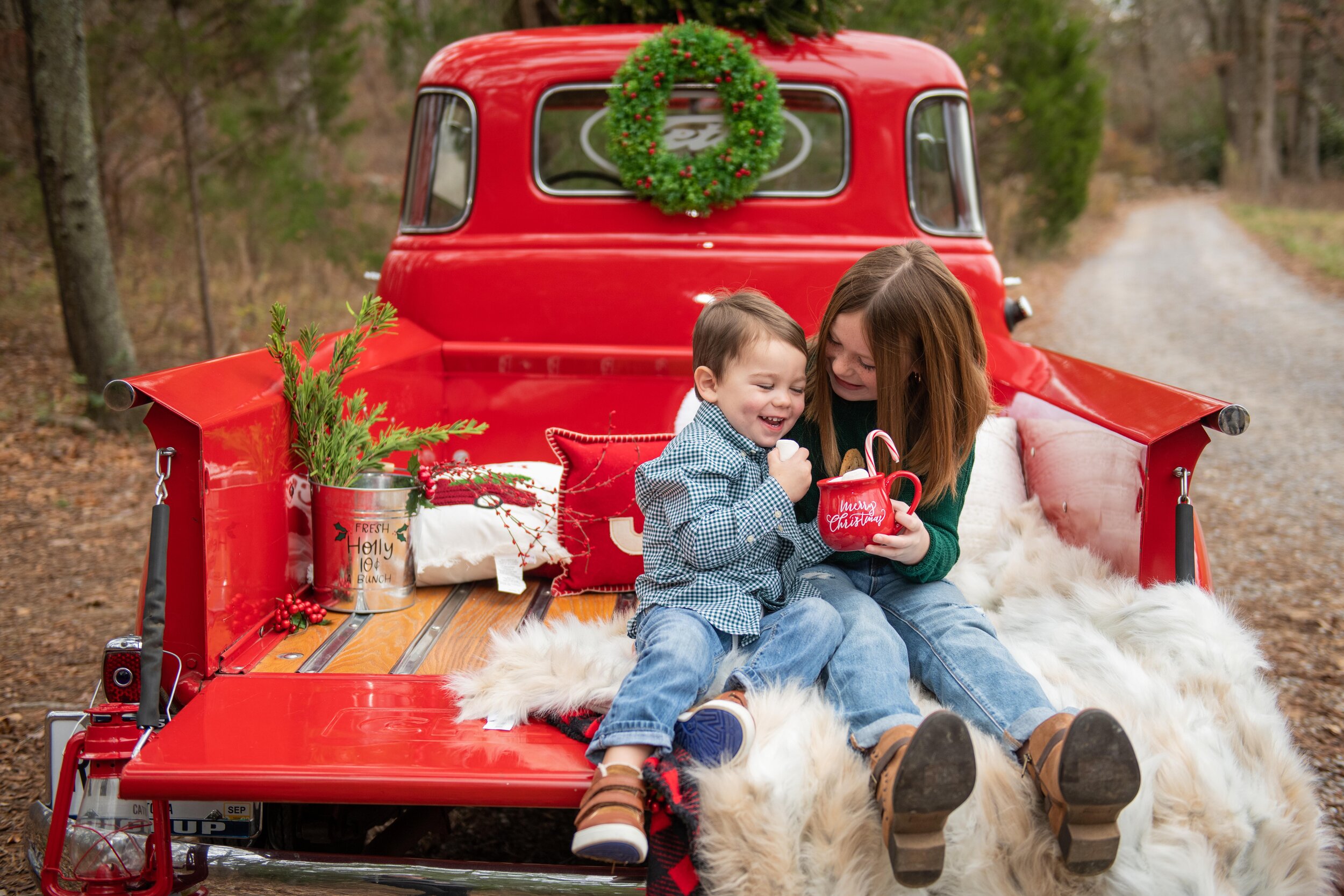 A red vintage truck carrying a Christmas tree through snow, the beloved image Coca-Cola's AI ad re-created with generators
