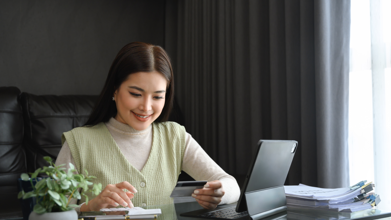 A focused investor reviewing documents beside a laptop before placing a first trade