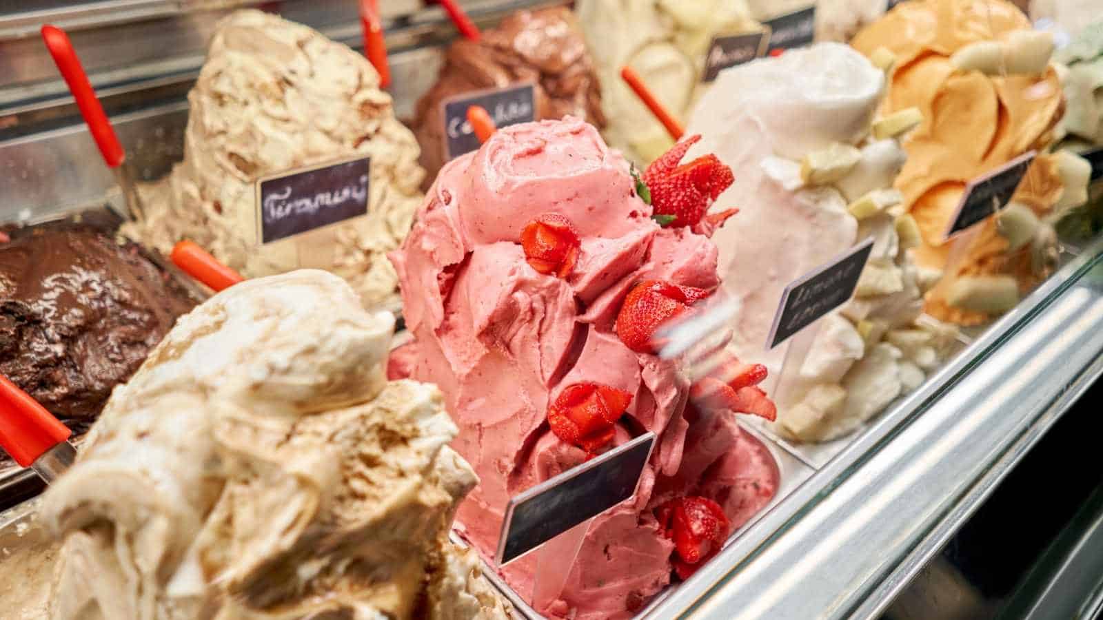 Gelato display case filled with colorful tubs