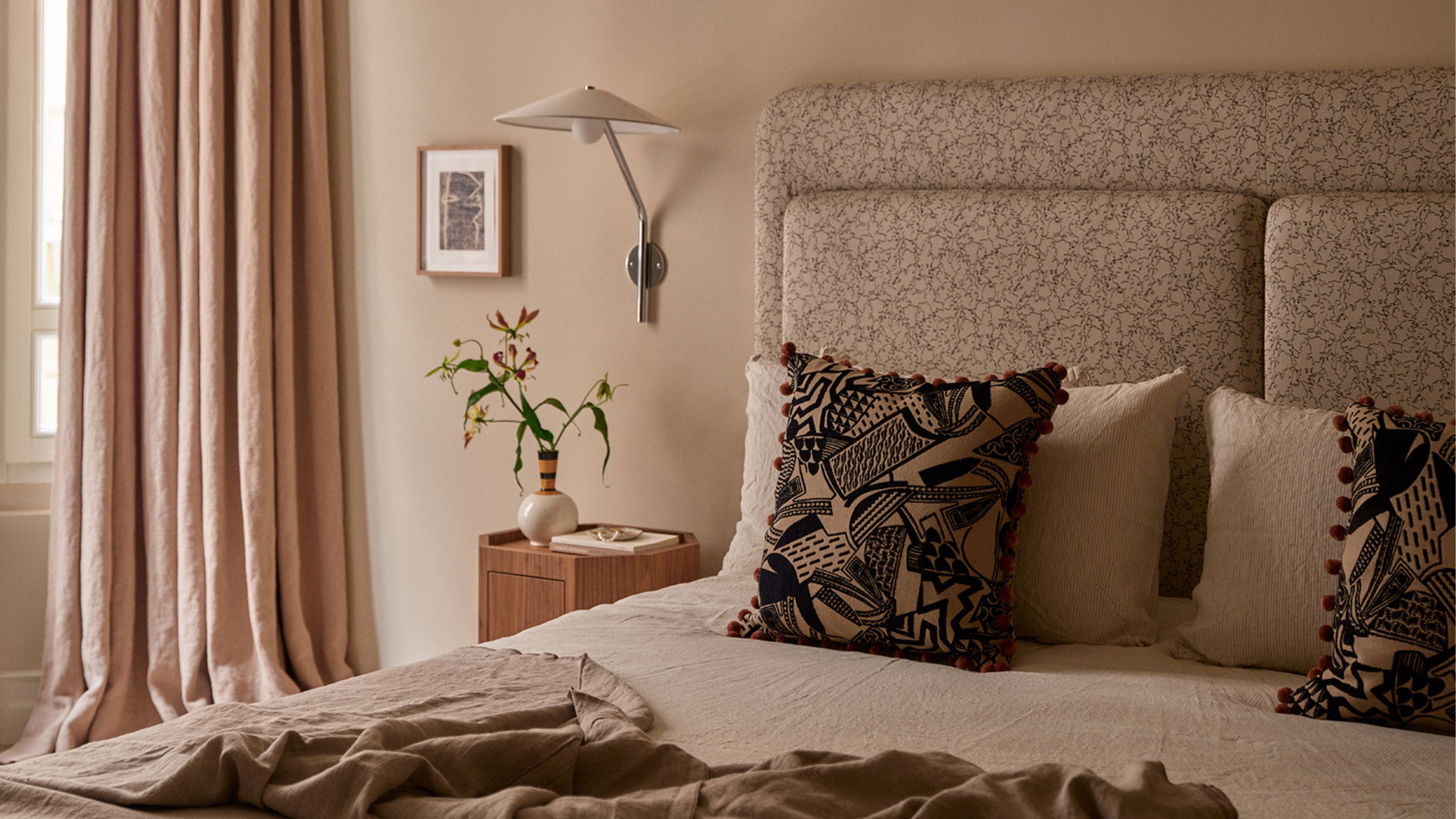 Warm master bedroom with upholstered headboard