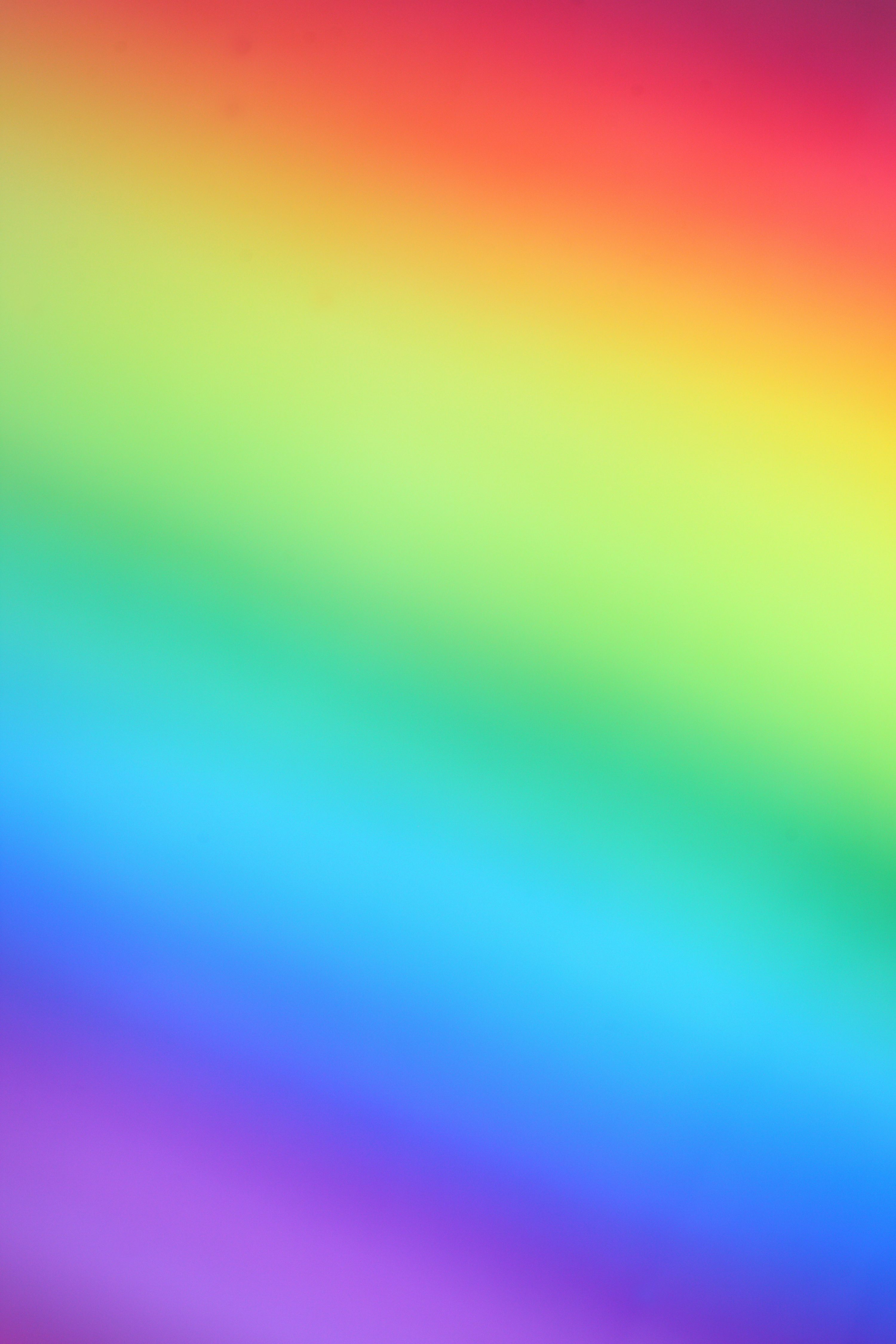 A full spectrum rainbow gradient flowing diagonally from red through yellow, green, cyan and blue to violet