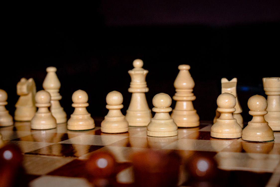 Chess pieces arranged on a board, one deliberate move at a time, the way the AI advertising playbook unfolds