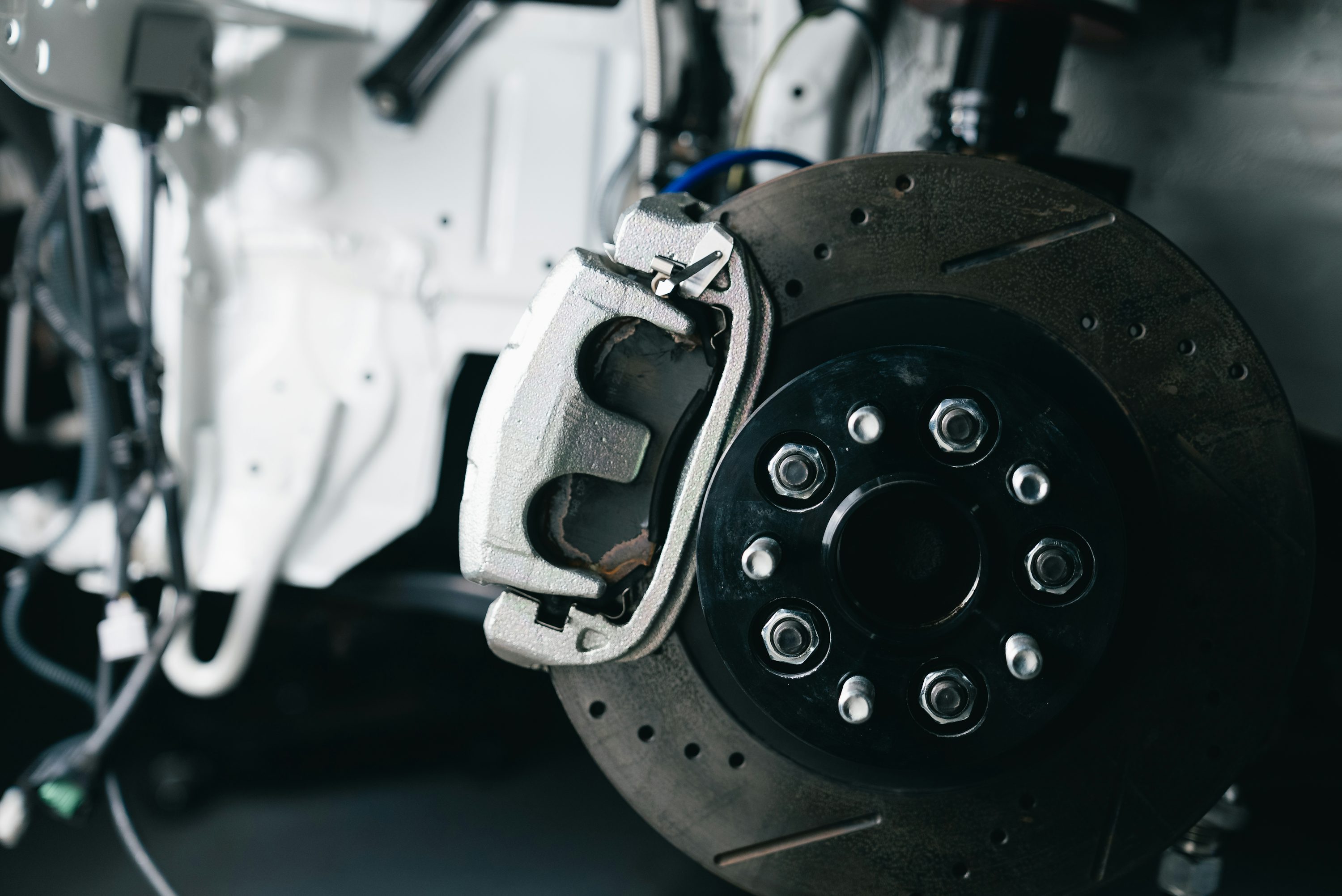 Automotive brake disc and caliper close-up during a brake repair service