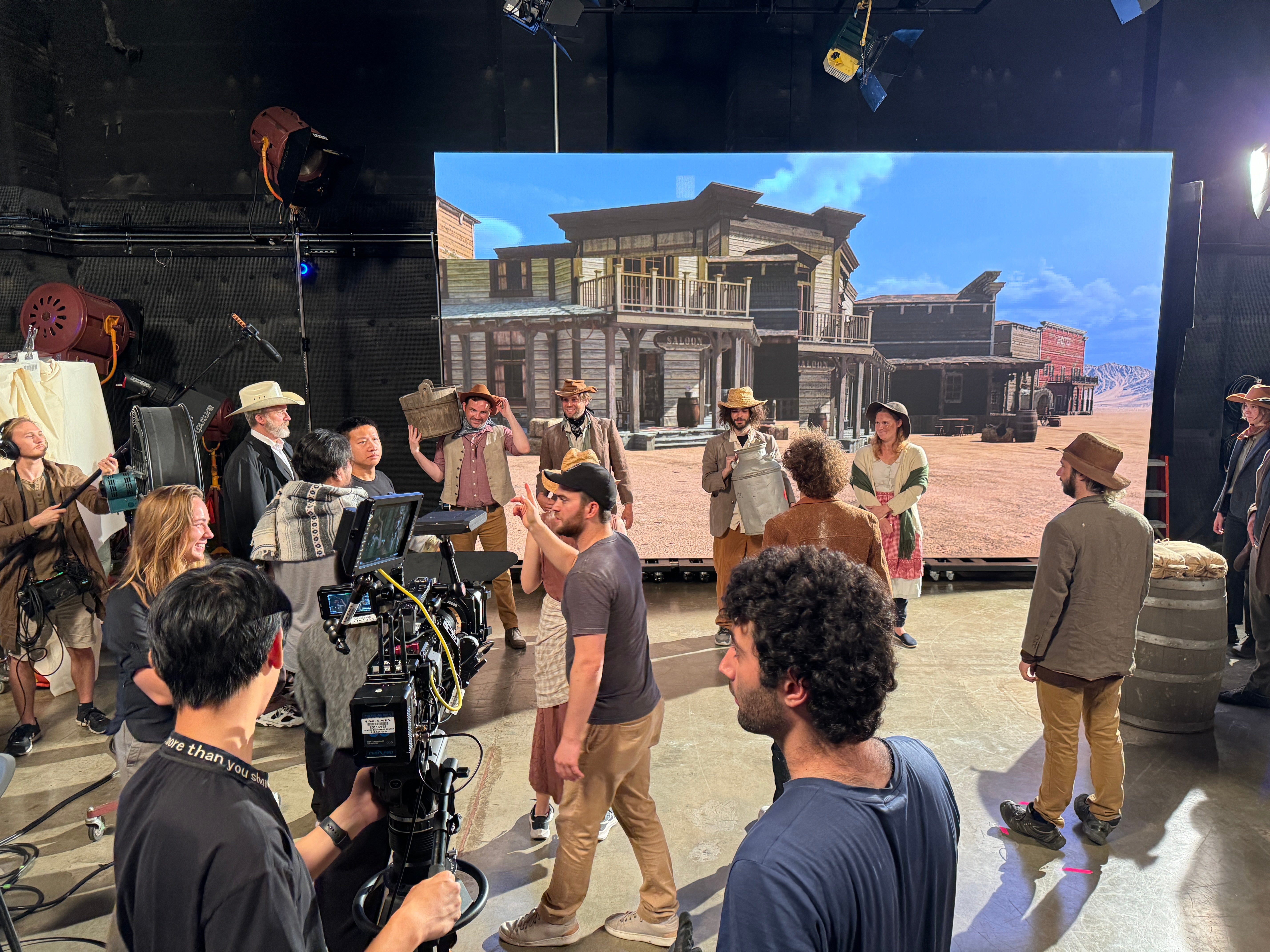 A virtual production stage with a camera crew in front of a giant LED wall, the traditional pipeline AI video ads now compete with