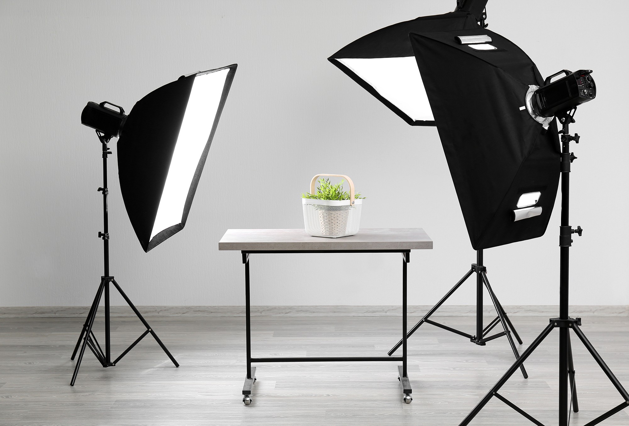 Professional photography studio set with softbox lights, camera and table