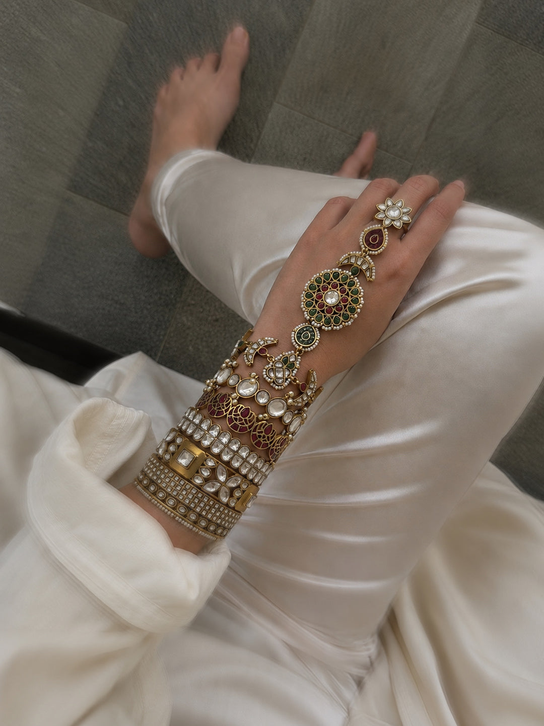 Hand adorned with traditional gold bangles and rings
