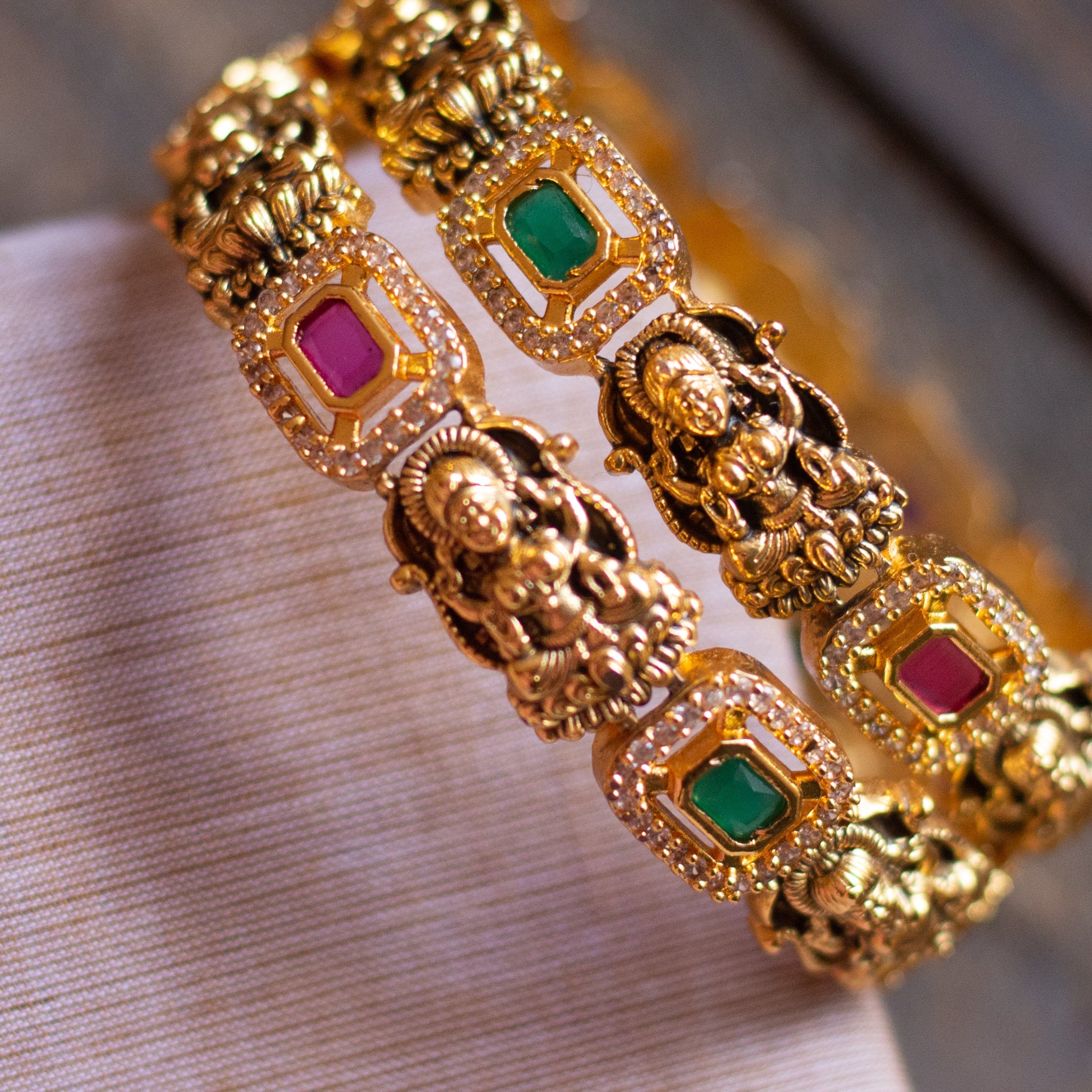 Gold bangles with goddess motifs