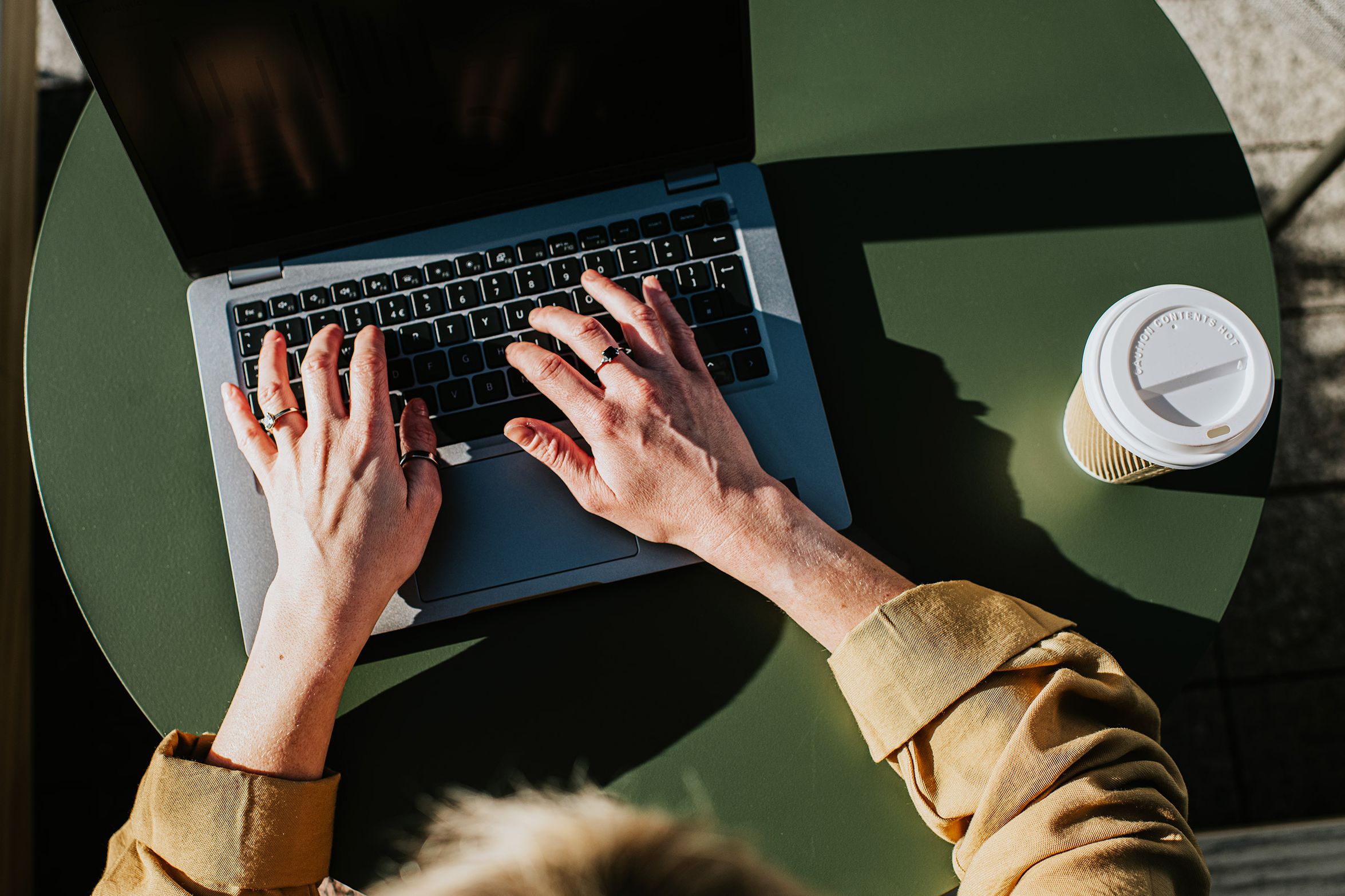 Person earning money online with AI tools on laptop and smartphone