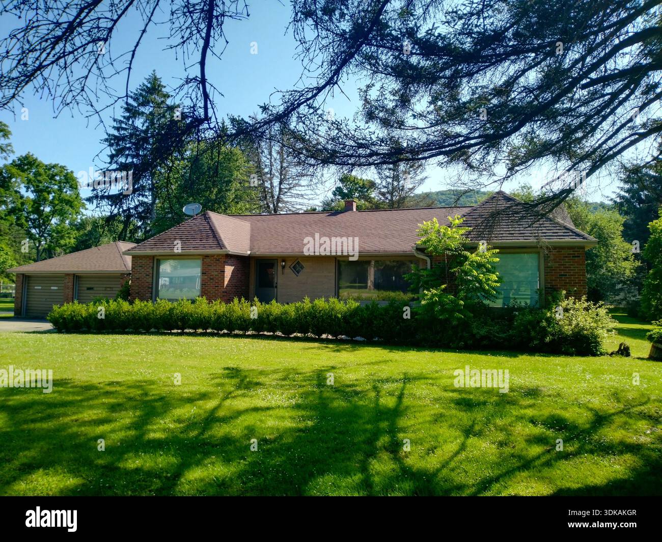 American suburban house with green lawn - factors that affect home insurance rates in 2023