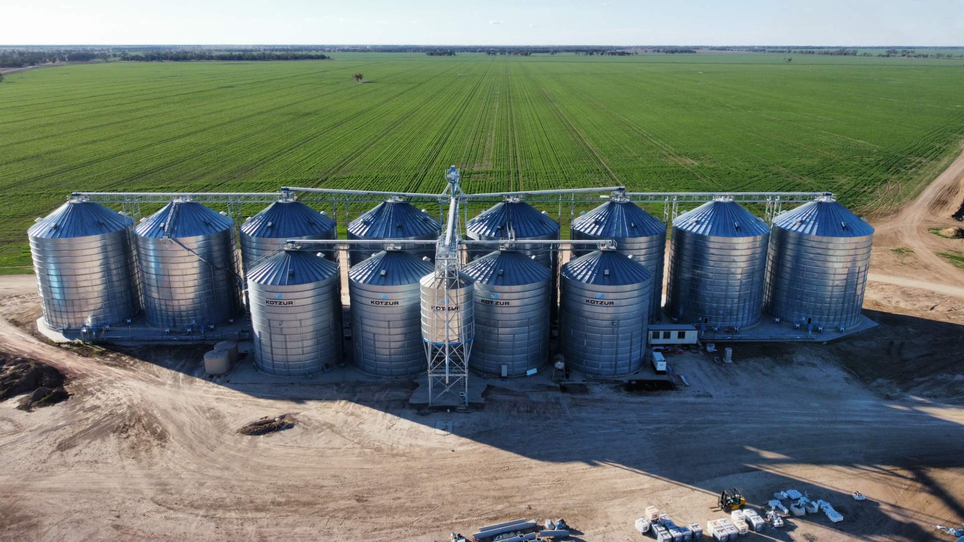 Modern animal feed mill facility with grain storage silos