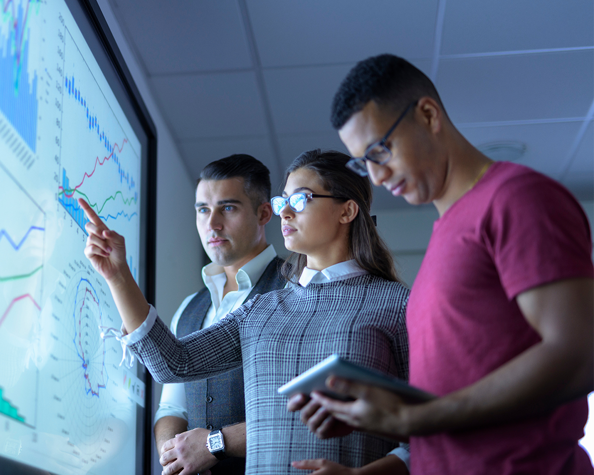 A team watching market action on a big screen while sentiment models score the mood behind every AI stock market move